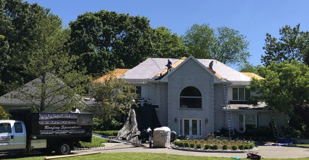 the Best Time for a New Roof Replacement in New Jersey New Roof Replacement a House with Some People Working on It