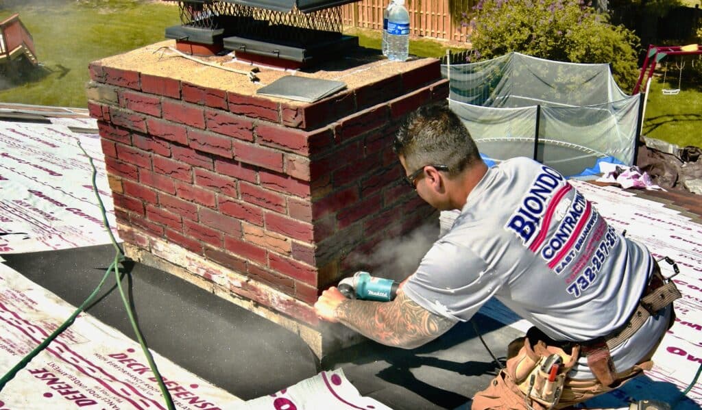 Professional Counter Flashing Application Brick Chimney Being Cut with Diamond Blade Saw Nj Roof Repair